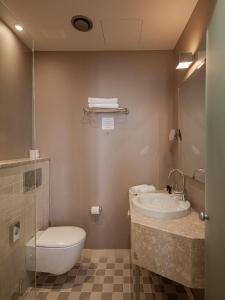 a bathroom with a toilet and a sink at Opera Hotel in Riga