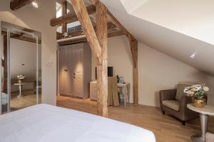 a bedroom with a bed and a chair in a room at Opera Hotel in Riga +69 photos