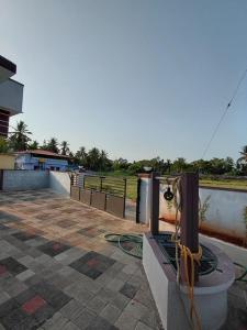 ailed patio with a fence and a field in the background at AGM Spacious Private AC 1BHK with Hall, Kitchen & Bath in Udupi