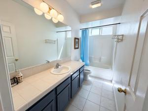 a bathroom with a sink and a toilet and a mirror at Spacious Private Bedrooms With Full Amenities Near Grocery Stores & Main Highway Routes in Fontana +21 photos