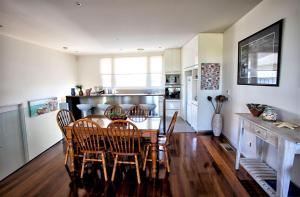 a kitchen with a dining room table and chairs at Bella Casa in Queenscliff +9 photos