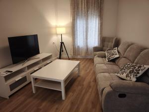 a living room with a couch and a coffee table at Casa Juanito Rute in Rute