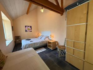 a bedroom with a bed and a glass shower at Au Bas Chalonge in Ligné