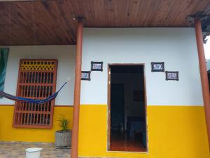 a yellow and white house with a door at La Escondida in Jardin +8 photos