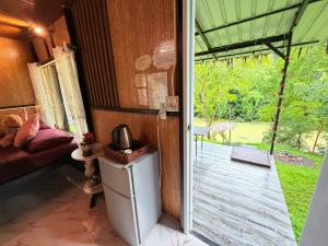 a room with a door open to a porch with a yard at Amornkeeree Khao Sok Camping in Khao Sok National Park +162 photos
