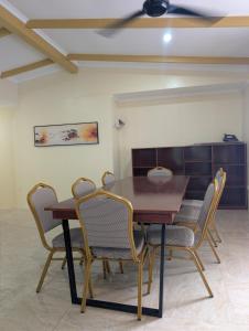 a dining room with a wooden table and chairs at Panatina Hillside 2 bedroom apartment in Honiara