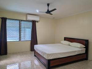 a bedroom with a bed and a ceiling fan at Panatina Hillside 2 bedroom apartment in Honiara