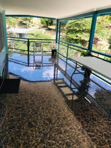 a balcony with a table and a chair and water at Panatina Hillside 2 bedroom apartment in Honiara