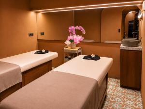 a room with two beds and a mirror at Villa Nico - Private Pool with Onsite Spa in Canggu