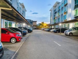 a parking lot with cars parked in front of buildings at JAA Homes 1-8 Pax Family Stay Jalan UMS KK in Kota Kinabalu