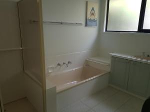 a bathroom with a bath tub and a sink at Buckley s 10 in Point Lonsdale +14 photos