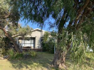 a house with a tree in front of it at Buckley s 10 in Point Lonsdale