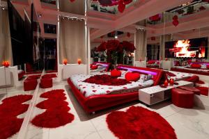 a bedroom with a large bed with red flowers on it at Le miroir secret in Gien