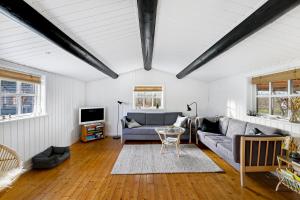 a living room with a couch and a table at Cozy Holiday Home Close To Forest And Beach in Hasle
