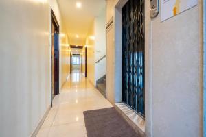 a hallway with a rug on a tile floor at Itsy Hotels M in Vijayawāda