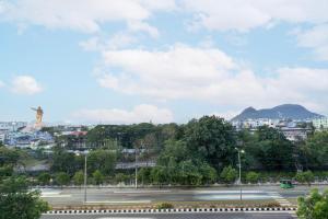 a view of a parking lot with a mountain in the background at Itsy Hotels M in Vijayawāda