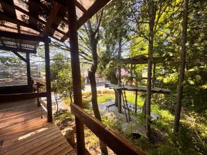 a porch of a cabin with a table and benches at みんなの家ポレポレ in Urugi