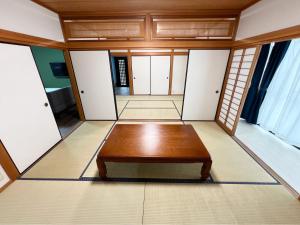 a room with a table in the middle of it at アザミヴィラ青島 in Miyazaki