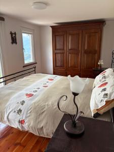 a bedroom with a bed and a lamp on a table at La Ville CIR00002 in Allein