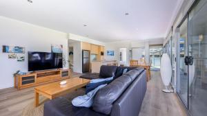 a living room with a couch and a tv at Del Mar 1 in Mandurah