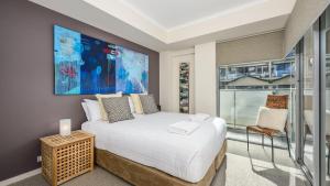 a bedroom with a large bed and a large window at Del Mar 1 in Mandurah