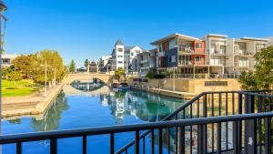 a view of a river with houses and a bridge at Del Mar 1 in Mandurah