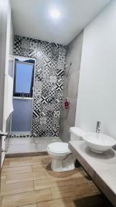 a bathroom with a toilet and a sink at Torre 23 in Oaxaca City +29 photos