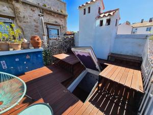 a wooden deck with a table and a chair at Apartment Blue Whale in Piran