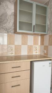 a kitchen with a cabinet and a refrigerator at Отель у моря Chester in Odesa
