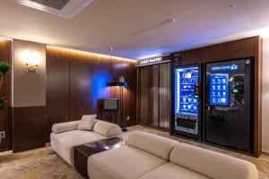 a living room with a video game machine at New Cheonji Hotel in Seoul
