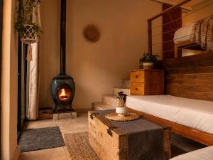 a bedroom with a bed and a wood stove at Kaaimans River Villa in Wilderness