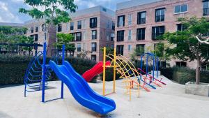 a playground with colorful slides in front of a building at Torre 23 in Oaxaca City