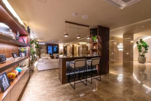 a kitchen and living room with a bar and chairs at New Cheonji Hotel in Seoul