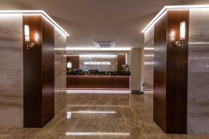 a lobby of a hotel with a reception desk at New Cheonji Hotel in Seoul