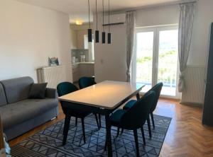 a living room with a table and chairs and a couch at Apartman Ivanka in Imotski