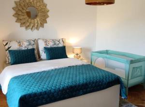 a bedroom with a blue bed and a mirror at Apartman Ivanka in Imotski