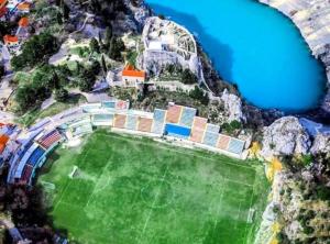 an aerial view of a soccer field next to the water at Apartman Ivanka in Imotski