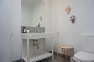 a bathroom with a sink and a toilet at Chevignon in Queenscliff +11 photos