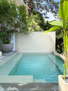 a swimming pool with blue water in a backyard at Hidden Bay Chaloklam in Chaloklum