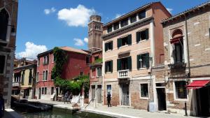 a group of buildings next to a canal at Apartment Cafoscari in Venice