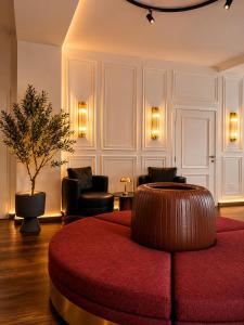 a living room with a red ottoman in a room at Hotel Nare in Boppard