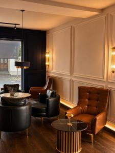 a living room with leather chairs and a table at Hotel Nare in Boppard