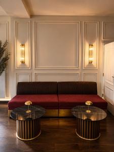 a living room with a couch and two tables at Hotel Nare in Boppard +17 photos