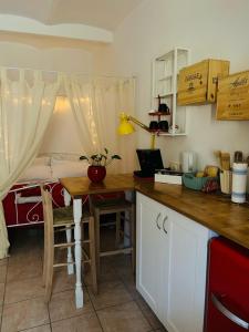 a kitchen with a table and a bed in the background at Casa Rossa in Ferentillo