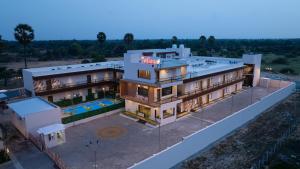 an aerial view of a building with a swimming pool at La Antaraa in Arumuganeri