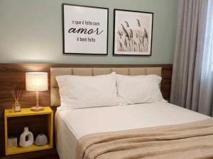 a bedroom with a bed and two pictures on the wall at Casa com piscina em Aldeia Velha in Quartéis