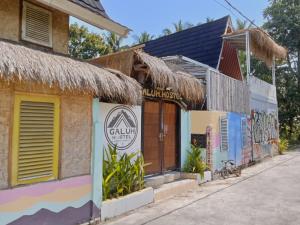 a building with graffiti on the side of it at Galuh Hostel Lombok in Pawenang