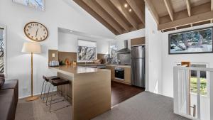 a kitchen with a large clock on the wall at Alpenglow in Dinner Plain