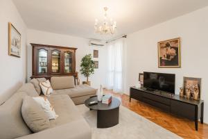 a living room with a couch and a tv at Mila in Herceg-Novi