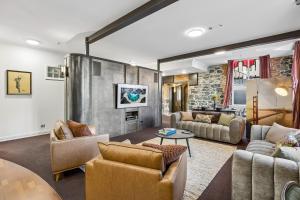 a living room with couches and a table at Chapel On Moray - Apartment in Dunedin